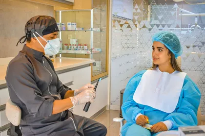 Dentist and All-on-6 patient discussing treatment options at a consultation desk — the first step in the quote process